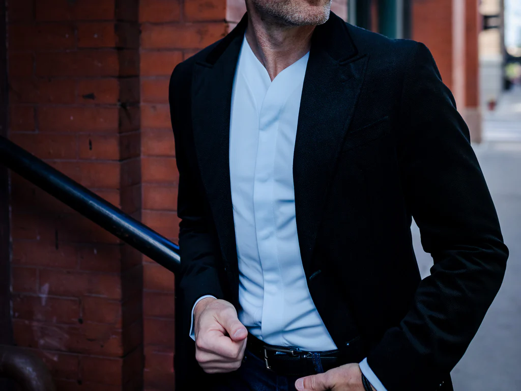 man wearing collarless shirt on the street